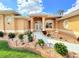 Close up view of the front entrance with colorful landscaped beds at 2329 Como St, Port Charlotte, FL 33948