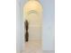 Welcoming hallway with a decorative arched alcove and neutral tile flooring at 2329 Como St, Port Charlotte, FL 33948