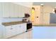 Updated kitchen featuring white cabinets, stainless steel appliances and granite countertops at 2329 Como St, Port Charlotte, FL 33948
