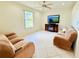 Bright living room with tile flooring, ceiling fan, and cozy recliners at 2329 Como St, Port Charlotte, FL 33948