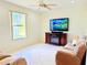 Comfortable living room with tile flooring, ceiling fan, and mounted TV at 2329 Como St, Port Charlotte, FL 33948