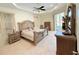 A naturally lit main bedroom featuring decorative furniture, ceiling fan, and access to the pool area at 2329 Como St, Port Charlotte, FL 33948