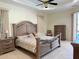 A naturally lit main bedroom featuring decorative furniture, a ceiling fan, and access to the pool area at 2329 Como St, Port Charlotte, FL 33948