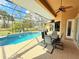 Relaxing screened-in pool area with an outdoor dining set, perfect for entertaining or enjoying quiet moments at 2329 Como St, Port Charlotte, FL 33948