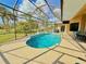 Inviting screened-in pool with a fountain feature and a view of the green landscape and backyard at 2329 Como St, Port Charlotte, FL 33948