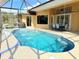 Beautiful backyard pool with screened enclosure, outdoor dining area, and water features at 2329 Como St, Port Charlotte, FL 33948