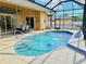 Sparkling swimming pool with screened enclosure, dining area, and spa access at 2329 Como St, Port Charlotte, FL 33948