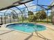 Inviting screened-in pool with a fountain feature and a view of the green landscape at 2329 Como St, Port Charlotte, FL 33948