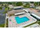 An aerial perspective highlights the sparkling pool, lounge areas and surrounding community buildings for relaxing outdoor experience at 24862 Us Highway 19 N # 3001, Clearwater, FL 33763