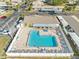 Aerial view of the community pool surrounded by lounge chairs and a covered patio area, ideal for outdoor enjoyment at 24862 Us Highway 19 N # 3001, Clearwater, FL 33763