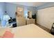 Bedroom with blue walls, soft carpet, and a comfortable bed with multiple pillows at 24862 Us Highway 19 N # 3001, Clearwater, FL 33763
