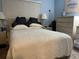 Comfortable bedroom featuring a large bed, soft lighting, and a dresser at 24862 Us Highway 19 N # 3001, Clearwater, FL 33763