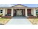 Inviting entrance to the community clubhouse with brick accents and a covered walkway at 24862 Us Highway 19 N # 3001, Clearwater, FL 33763