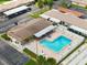 Aerial view of the community pool with ample seating, landscaping, and parking at 24862 Us Highway 19 N # 3001, Clearwater, FL 33763