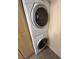Stacked washer and dryer adjacent to storage cabinets in laundry area at 24862 Us Highway 19 N # 3001, Clearwater, FL 33763