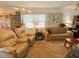 Well-lit living room with comfortable seating, a glass table, and decorative lighting at 24862 Us Highway 19 N # 3001, Clearwater, FL 33763