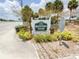 Community sign with lush landscaping, creating a welcoming entrance to Hillcrest Villas at 24862 Us Highway 19 N # 3001, Clearwater, FL 33763