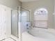 Bathroom featuring soaking tub, separate glass shower, and natural light at 25419 Seven Rivers Cir, Land O Lakes, FL 34639