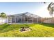 Screened-in pool surrounded by green lawn offers a perfect blend of indoor-outdoor living at 25419 Seven Rivers Cir, Land O Lakes, FL 34639