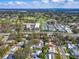 Community aerial view featuring golf course, tennis courts, residences, and lush landscaping at 2671 Clubhouse N Dr, Clearwater, FL 33761