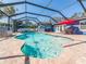 Enjoy a leisurely swim in the in-ground pool with a screened enclosure at 2671 Clubhouse N Dr, Clearwater, FL 33761