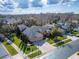 Aerial view of a residential home with well-manicured lawn and a three car brick driveway at 2903 Marble Crest Dr, Land O Lakes, FL 34638