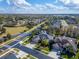 Aerial view of a residential home with a well-maintained lawn and a brick-paved driveway at 2903 Marble Crest Dr, Land O Lakes, FL 34638