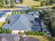 Overhead shot of large house with a screened in pool, well-maintained landscaping, and fire pit area at 2903 Marble Crest Dr, Land O Lakes, FL 34638