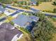 Aerial view shows a home with mature landscaping, fenced pool area, and well-maintained lawn at 2903 Marble Crest Dr, Land O Lakes, FL 34638