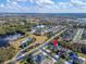 An aerial view showcasing neighborhood with mature trees, lush lawns, and a large pond at 2903 Marble Crest Dr, Land O Lakes, FL 34638