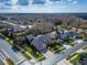 Aerial view of a home with a well-maintained lawn, mature trees, and a brick-paved driveway at 2903 Marble Crest Dr, Land O Lakes, FL 34638