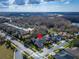 Aerial view of a home with a well-maintained lawn, mature trees, and a brick-paved driveway at 2903 Marble Crest Dr, Land O Lakes, FL 34638