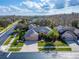 An aerial view of a well-maintained home showcasing lush landscaping and a brick-paved driveway at 2903 Marble Crest Dr, Land O Lakes, FL 34638