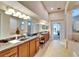 Expansive bathroom featuring dual sinks, a vanity area, and a separate tub and shower at 2903 Marble Crest Dr, Land O Lakes, FL 34638