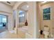 Bright bathroom featuring a soaking tub, separate shower, and neutral tile at 2903 Marble Crest Dr, Land O Lakes, FL 34638