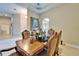Elegant dining room with tray ceilings, neutral paint, and a stunning dark wood table at 2903 Marble Crest Dr, Land O Lakes, FL 34638