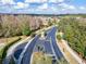 Aerial view of the community entrance lined with trees leading into the neighborhood at 2903 Marble Crest Dr, Land O Lakes, FL 34638