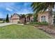 Charming single-Gathering home showcasing a well-manicured lawn, lush landscaping, and a three-car garage at 2903 Marble Crest Dr, Land O Lakes, FL 34638
