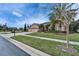 Charming home with a three-car garage, lush landscaping, and a brick-paved driveway at 2903 Marble Crest Dr, Land O Lakes, FL 34638