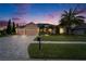 Charming home with a three-car garage, lush landscaping, and a brick-paved driveway at 2903 Marble Crest Dr, Land O Lakes, FL 34638