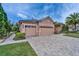 Spacious three-car garage with brick-paved driveway and manicured landscaping at 2903 Marble Crest Dr, Land O Lakes, FL 34638