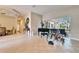 Spacious living room with tile flooring, a piano, access to the patio, and abundant natural light at 2903 Marble Crest Dr, Land O Lakes, FL 34638