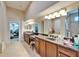 Spacious bathroom with double vanities, granite countertop, and access to walk-in closet at 2903 Marble Crest Dr, Land O Lakes, FL 34638