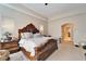 Main bedroom featuring a decorative tray ceiling, large bed, and a doorway to another room at 2903 Marble Crest Dr, Land O Lakes, FL 34638