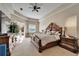 Spacious main bedroom suite with a tray ceiling, carpet flooring, and access to the pool area at 2903 Marble Crest Dr, Land O Lakes, FL 34638