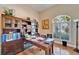 Spacious office featuring custom desk with built in bookcases and large window at 2903 Marble Crest Dr, Land O Lakes, FL 34638