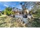 Outdoor living space featuring a screened lanai, patio with a fire pit, and lush landscaping creating a private backyard oasis at 2903 Marble Crest Dr, Land O Lakes, FL 34638