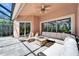 A covered patio features comfortable seating with natural light, a ceiling fan, and access to the backyard at 2903 Marble Crest Dr, Land O Lakes, FL 34638