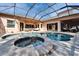 A screened-in pool with a built-in spa offers outdoor seating on a paved patio at 2903 Marble Crest Dr, Land O Lakes, FL 34638