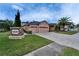Community sign with manicured landscaping and a view of a well-maintained home in the background at 2903 Marble Crest Dr, Land O Lakes, FL 34638